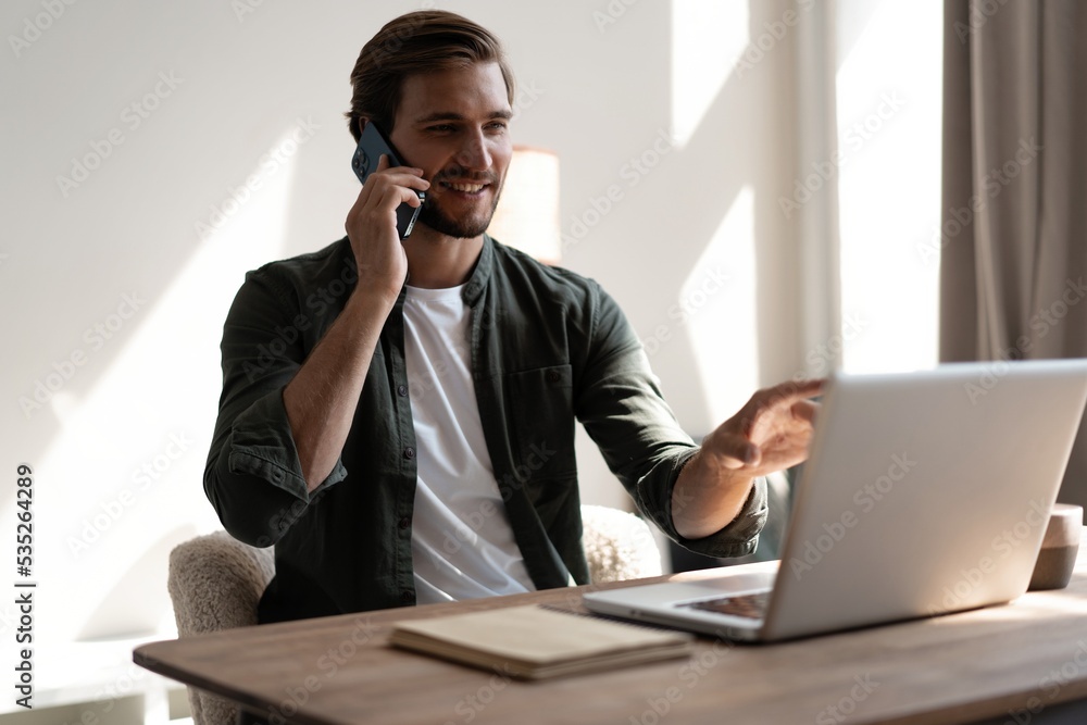 Young businessman talking on phone. Handsome man using his smartphone. Young businessman talking on phone. Handsome man using his smartphone.