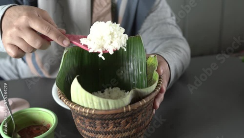 people take rice from a container in Sundanese called boboko photo