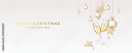 Christmas and New Year greeting card with wineglasses with champagne, snowflakes, christmas balls, ribbons and confetti.