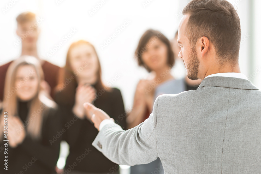 blurred image of a group of young people applauding their speaker blurred image of a group of young people applauding their speaker