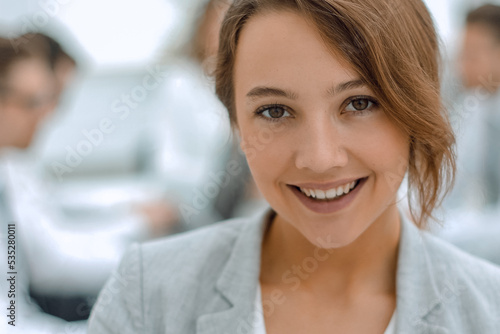 portrait of young business woman on blurred office background
