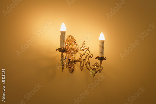 фотографія Decorative vintage wall sconce lamp candle with warm light