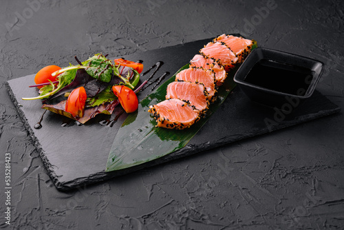 Salmon tataki in sesame with salad photo