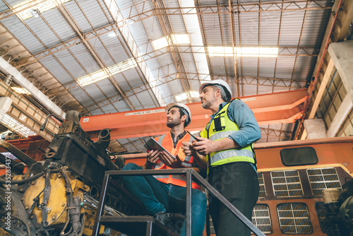 professional technician engineer with safety helmet hard hat working in industrial manufacturing factory, men at work to checking equipment of machinery production technology or construction operating