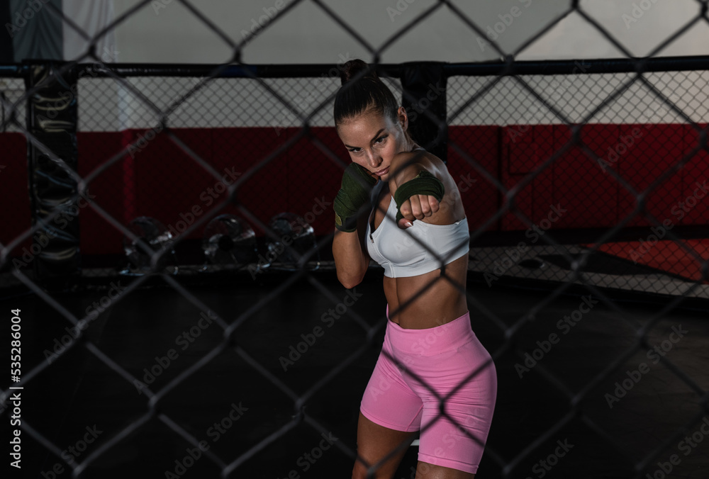 Young woman or girl mixed martial arts boxer fighter training in the