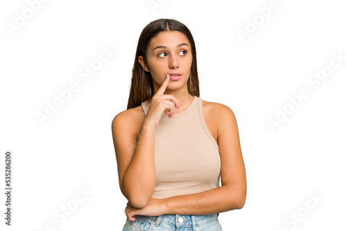 Young Indian woman isolated cutout removal background looking sideways with doubtful and skeptical expression. © Asier