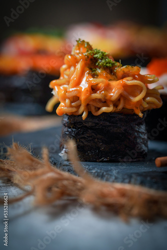 Sushi is a Japanese dish of prepared vinegared rice (鮨飯, sushi-meshi), usually with some sugar and salt, accompanied by a variety of ingredients