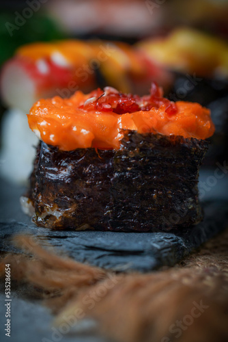 Sushi is a Japanese dish of prepared vinegared rice (鮨飯, sushi-meshi), usually with some sugar and salt, accompanied by a variety of ingredients