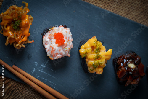 Sushi is a Japanese dish of prepared vinegared rice (鮨飯, sushi-meshi), usually with some sugar and salt, accompanied by a variety of ingredients