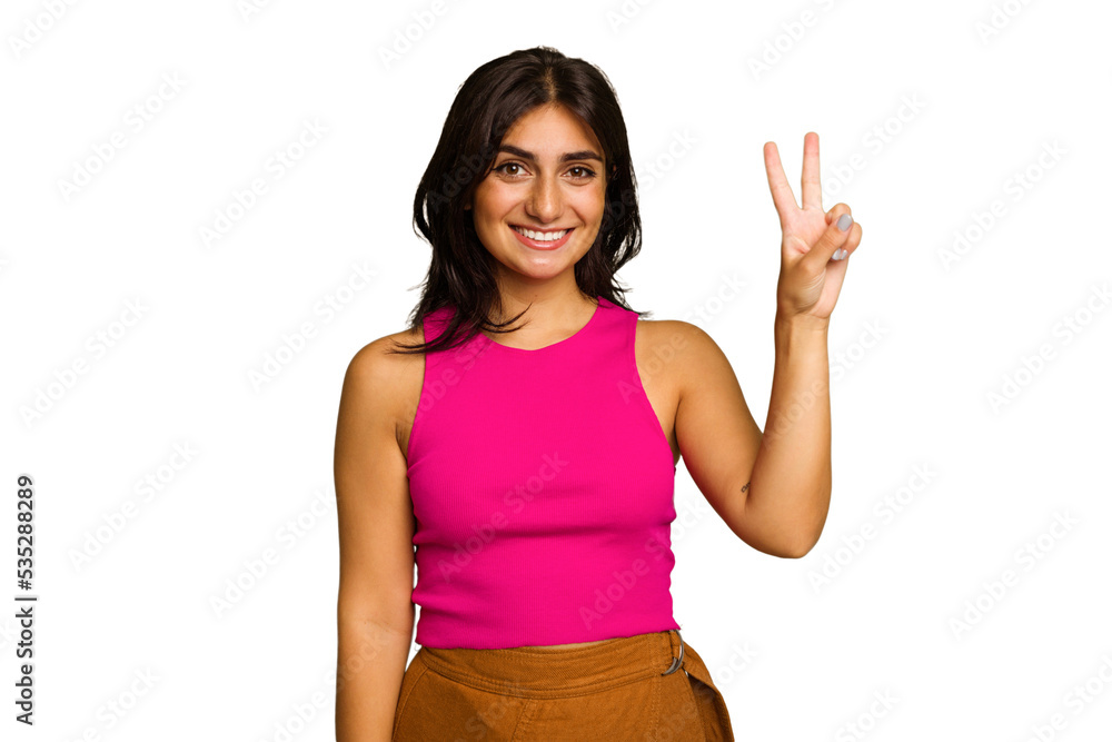 Young Indian woman isolated on green chroma background joyful and carefree showing a peace symbol with fingers. Young Indian woman isolated on green chroma background joyful and carefree showing a peace symbol with fingers.