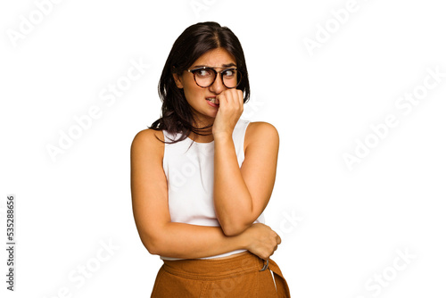 Bild auf Leinwand Young Indian woman isolated on green chroma background biting fingernails, nervous and very anxious