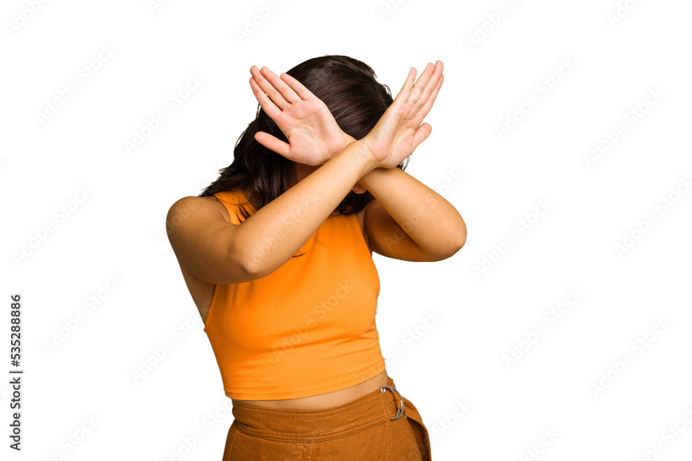 Young Indian woman isolated on green chroma background keeping two arms crossed, denial concept. Young Indian woman isolated on green chroma background keeping two arms crossed, denial concept.