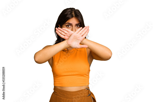 Young Indian woman isolated on green chroma background doing a denial gesture