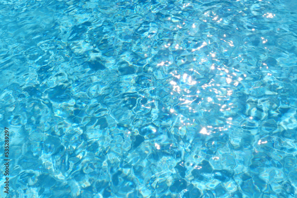 Swimming pool clear water with sun reflection.