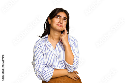 Young Indian woman isolated on green chroma background crying, unhappy with something, agony and confusion concept.