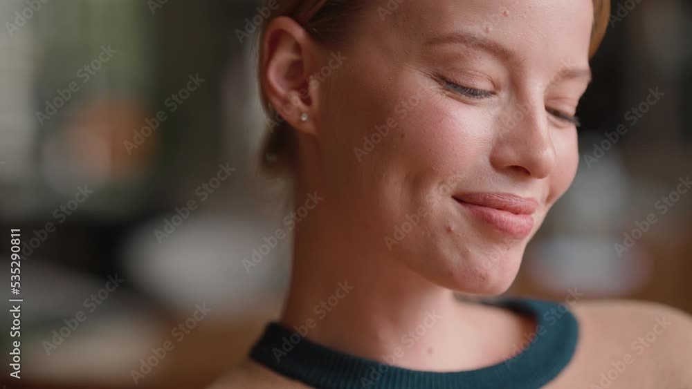 Smiling blonde woman looking to the side in cafe Smiling blonde woman looking to the side in cafe