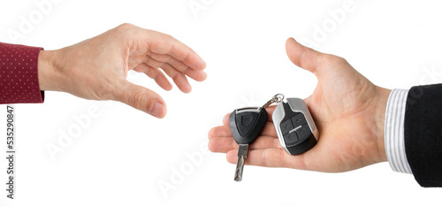 hand of businessman passing car keys to hand, isolated 