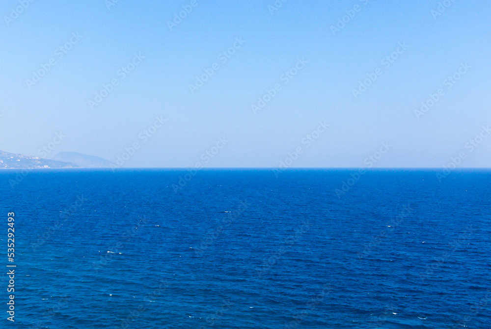 The sea is blue to the horizon during the summer day The sea is blue to the horizon during the summer day