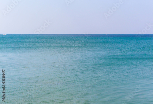 The sea is blue to the horizon during the summer day © Lina
