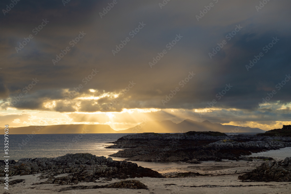 Shafts of sunlight at sunset on a scottish beach