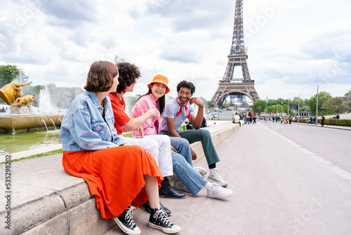 Multiethnic group of young happy teens friends bonding and having fun while visiting Eiffel Tower area in Paris, France © oneinchpunch