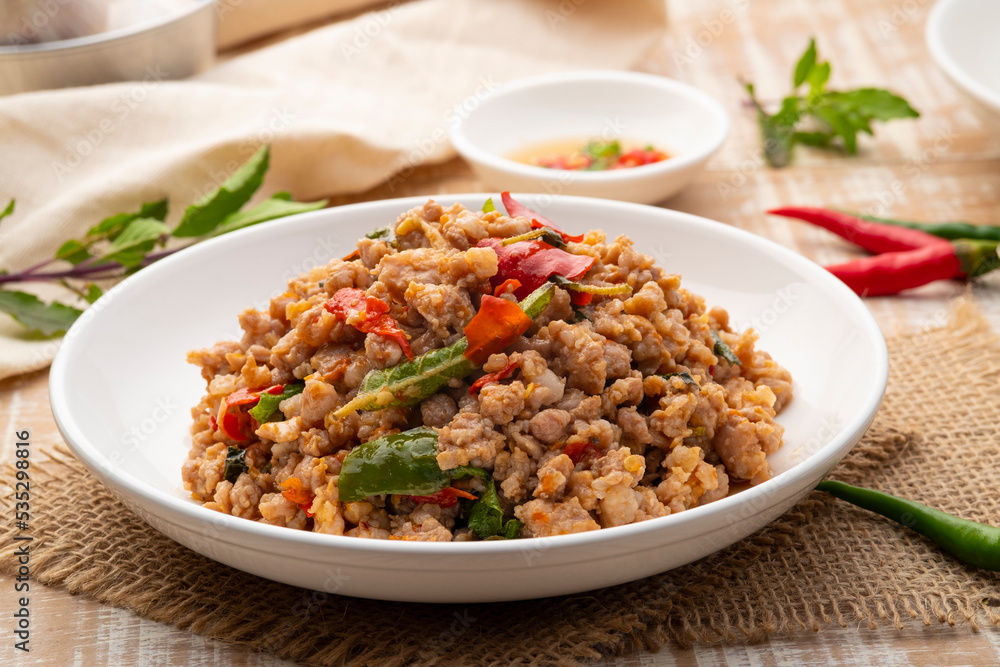 Stir Fried Minced Pork with Basil leave on white plate Stir Fried Minced Pork with Basil leave on white plate