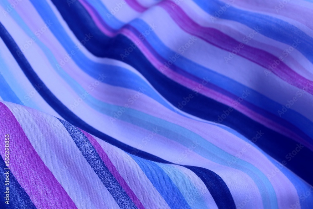 Striped white and blue fabric with beautiful pleats. Satin, linen, cotton or silk. Solid background.
