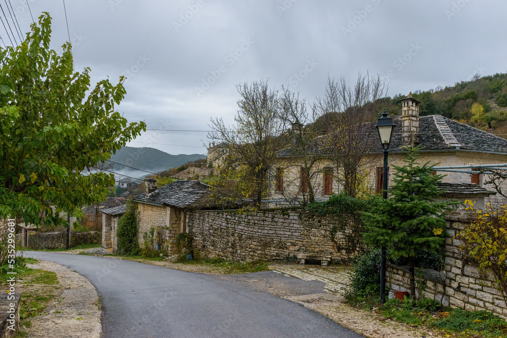 View of the stone village Ano Pedina during autumn with its architectural traditional old stone  buildings located on Tymfi mount, Zagori, Epirus, Greece,