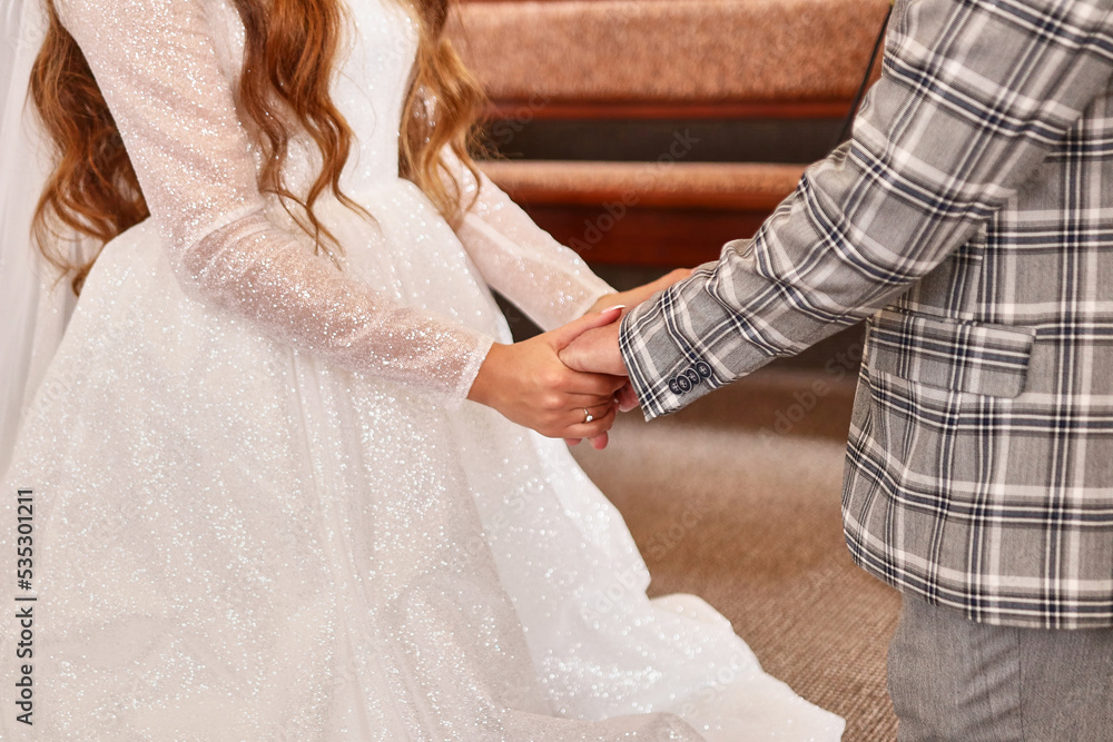 During the wedding ceremony, the bride and groom hold hands. Wedding celebration. During the wedding ceremony, the bride and groom hold hands. Wedding celebration.