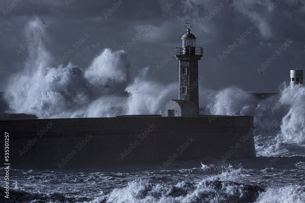 Stormy wave spash in the old river mouth lighthouse
