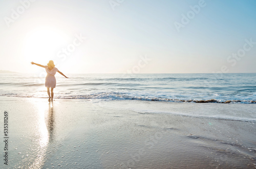 Young woman having fun walking on seaside.