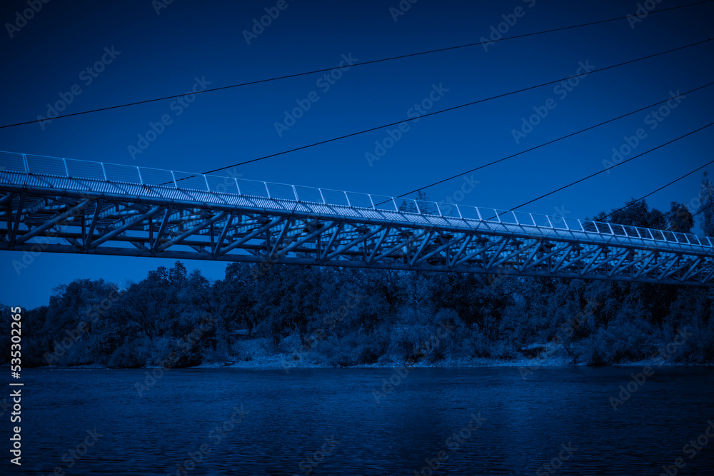 Fototapeta premium Night landscape at Sacramento River with the view of Sundial Bridge in Redding, Northern California