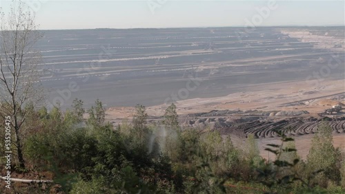 camera pan over anti dust water sprayer in action with  bucket-wheel excavator