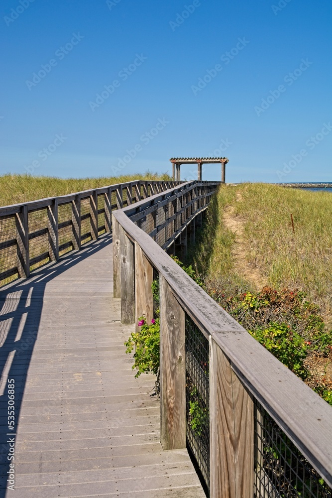 Boardwalk across sand dunes towards Atlantic Ocean beach at Plum Island