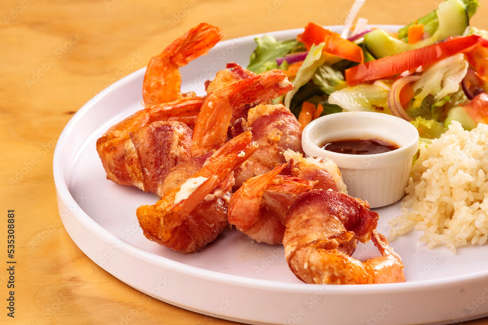 Fried shrimp with bacon, sweet sauce, salad and rice, food, gastronomy Fried shrimp with bacon, sweet sauce, salad and rice, food, gastronomy