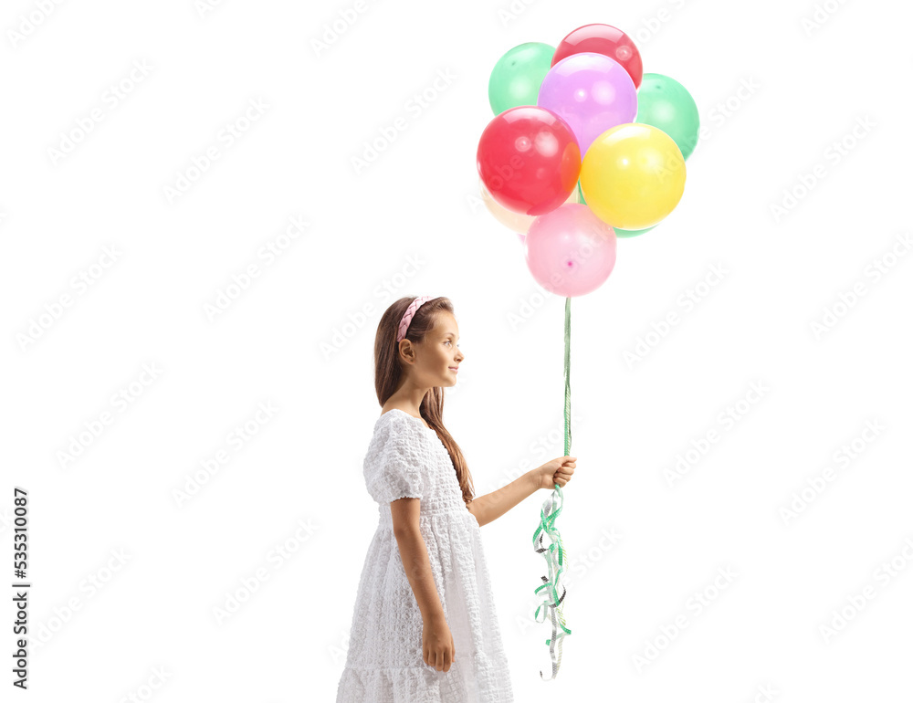 Profile shot of a girl in a white dress holding a bunch of balloons