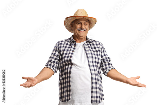 Happy mature farmer with a straw hat gesturing with hands