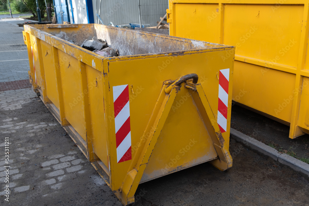 Reduced size of small and narrow yellow metal dumpsters container