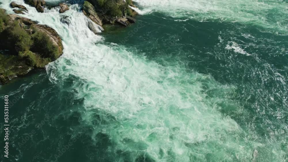 Rhine waterfalls from high altitude reveal shot with Schloss Laufen, sunny day, Schaffhausen, Switzerland Rhine waterfalls from high altitude reveal shot with Schloss Laufen, sunny day, Schaffhausen, Switzerland