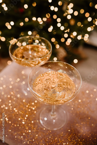 New Year's Eve 2022-2023 Celebration Background with Champagne. Champagne glasses on glitter background. Three champagne glasses ready to bring in the New Year.