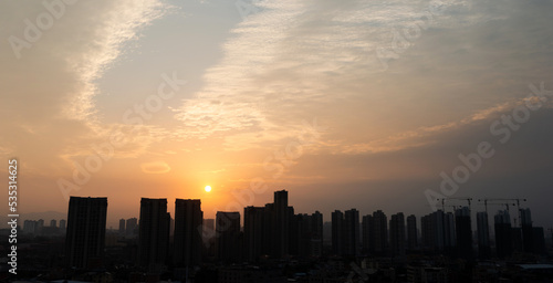 City buildings under sunset sky