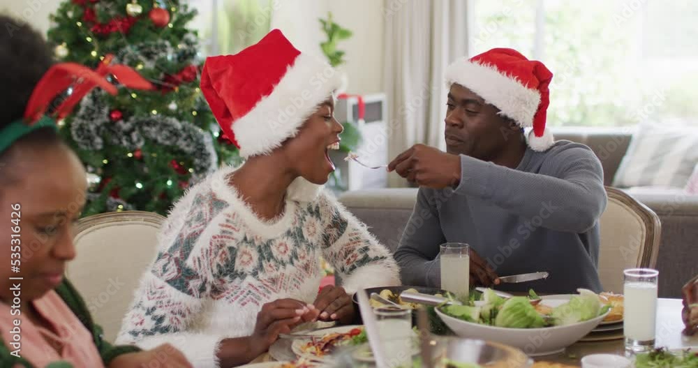 Happy african american family having christmas dinner Happy african american family having christmas dinner
