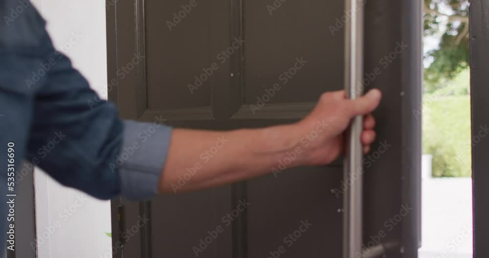 Happy caucasian male deliverer with box of vegetables opening door Happy caucasian male deliverer with box of vegetables opening door