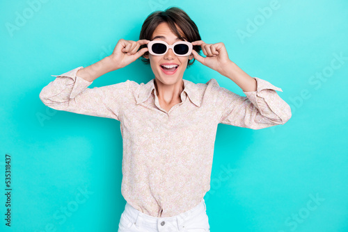 Photo of impressed bob hairdo young lady wear glasses white shirt isolated on teal color background