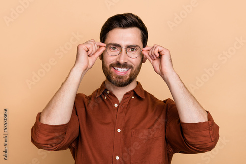 Portrait of positive satisfied person hands touch glasses toothy beaming smile isolated on beige color background