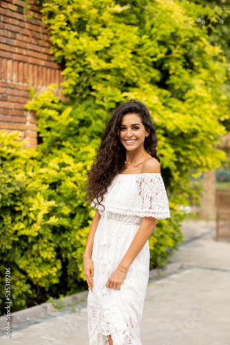 Pretty young curly hair woman in the park