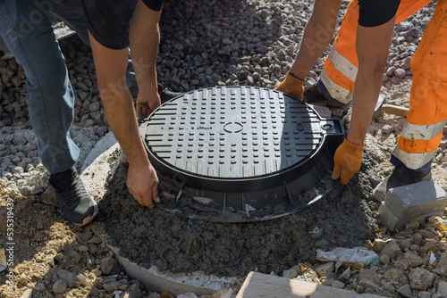Wall Mural A cast iron sewer installed in concrete well, preparation for installation of wa