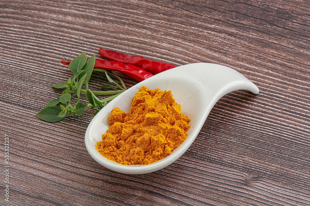 Yellow vibrant curcuma powder in the bowl Yellow vibrant curcuma powder in the bowl
