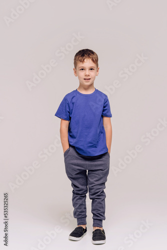 boy wearing blue t-shirt on grey © Cavan