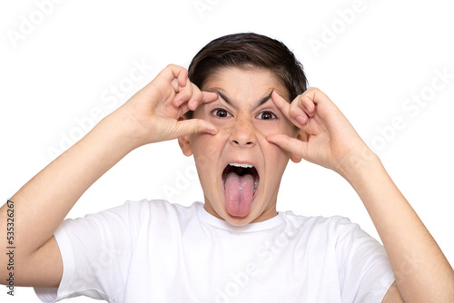 Kid making a face and showing his tongue. Isolated on white background